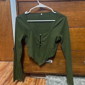 Long sleeve, flowy sleeves. Cute cut at the bottom